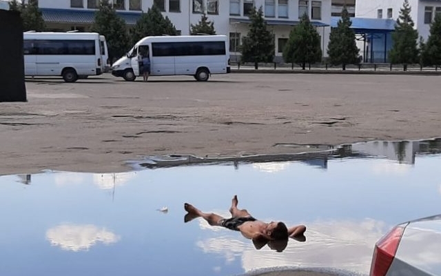 Курьезы: В Запорожской области мужчина принимал водные процедуры в большой луже Фото № 0